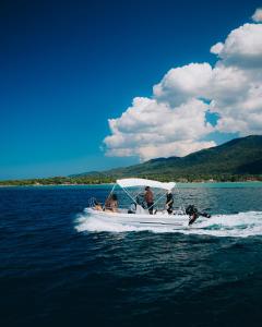 a group of people on a boat in the water at Alexandros Hotel Apartments in Vourvourou