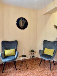 two chairs and two candles on tables in a room at Amirov Garden - Free parking & Free beach area in Kranevo