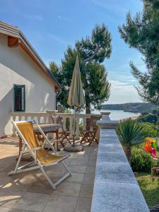 a patio with a table and an umbrella and chairs at Appartamenti Serena in Peschici