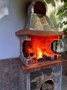 a brick oven with a fire inside of it at Amirov Garden in Kranevo