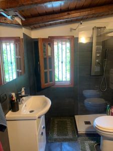 a bathroom with a sink and a toilet at La Casa Di Iside A Mare in Catania