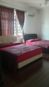 two beds in a room with a window at DamaiSari Tawang in Bachok +7 photos