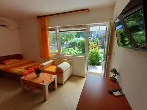 a room with a bed and a table and a window at Dom Zaharievi in Byala