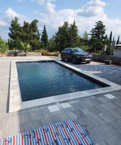a car parked in a parking lot with a pool of water at Apartman Lidija in Starigrad