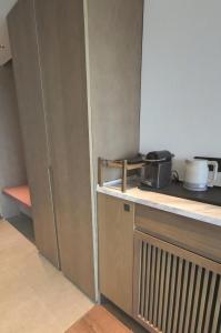 a kitchen with a counter with a toaster and a appliance at Beijing Marriott Hotel Yanqing in Yanqing