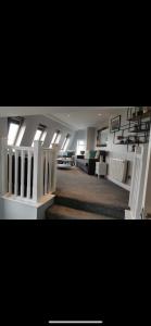 a large living room with white furniture and windows at Seaview Terrace in Skerries