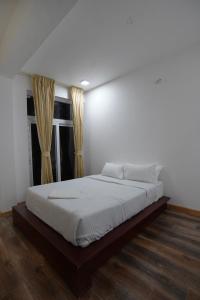 a large bed in a bedroom with a window at Richfields in Ooty