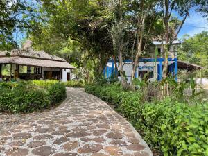 a stone path in front of a house at Blue EmOcean resort in Moyo Island
