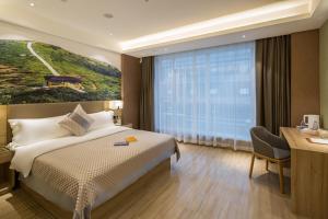 Postel nebo postele na pokoji v ubytování Morning Hotel, Changsha Provincial Government Metro Station