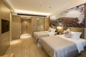 Postel nebo postele na pokoji v ubytování Morning Hotel, Changsha Provincial Government Metro Station