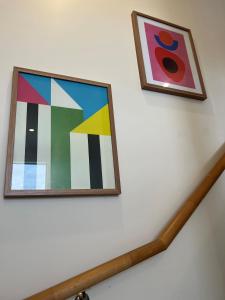 two pieces of art hanging on a white wall at Adorable 1 bedroom Unit in Coombs in Weston Creek