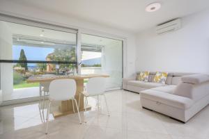 a living room with a table and chairs and a couch at Apartment Vengust in Malinska
