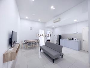 a living room with a couch and a kitchen at KWEN Loft - City Centre Imago 3BR l 2BR l Studio in Kota Kinabalu