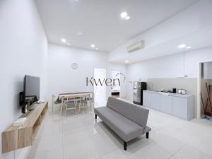 a living room with a couch and a kitchen at KWEN Loft - City Centre Imago 3BR l 2BR l Studio in Kota Kinabalu