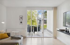 a white living room with a sliding glass door at Beautiful Apartment In Helsingr With 1 Bedrooms And Wifi in Helsingør