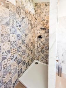 a bathroom with a shower with mosaic tiles at Eleonora in Banjole +39 photos