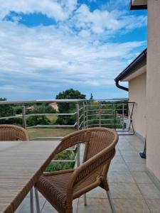 a table and chairs on a balcony with a view at Appartments D&D in Peroj