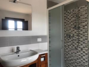 a bathroom with a white sink and a shower at Podere San Lorenzo in Terranuova Bracciolini