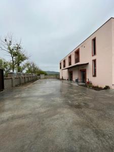 an empty parking lot in front of a building at hOlarooms N1 in Sachure +11 photos