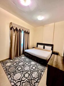 a bedroom with a bed and a rug at Dream Palace Hotel in Ajman 