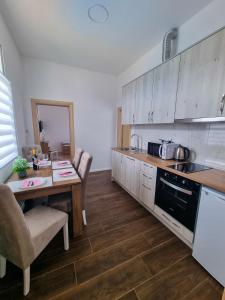 a kitchen with a table and a counter top at Villa Danijela in Janjina