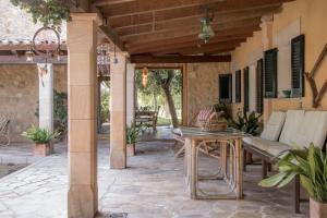 an outdoor patio with a table and chairs at Petit Torrent Fals in Santa Eugenia