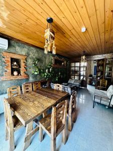 a dining room with a wooden table and chairs at Liel in Tbilisi City
