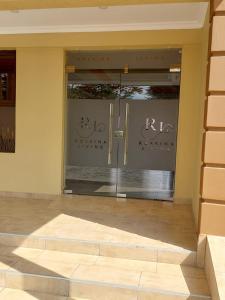 a glass door of a building with a sign on it at Rossina Living in Naivasha