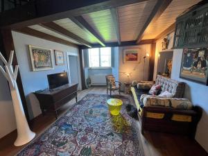 a living room with a couch and a tv at La Casa di Clara nella Rocca in Farnese