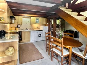 a kitchen with a wooden table and a table and chairs at Jinney Ring in Leintwardine
