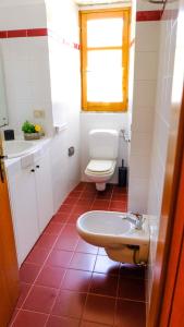 a bathroom with a toilet and a sink at La Casa dei due Ulivi in Capo dʼOrlando