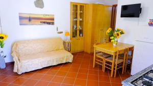 a bedroom with a bed and a table and a desk at La Casa dei due Ulivi in Capo dʼOrlando