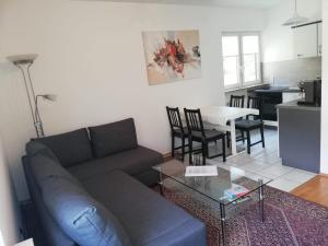 uma sala de estar com um sofá e uma mesa em Haus Lucia, mit Pool und Sauna, Appartment 4 em Schönwald