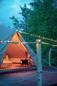 a tent with christmas lights on it with a bench at Yatu in Drábsko