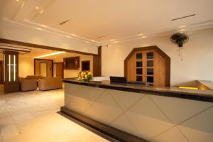 a lobby of a hotel with a reception counter at Hotel Keerthi in Trivandrum