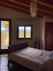 a bedroom with a bed and a window at Petit Torrent Fals in Santa Eugenia