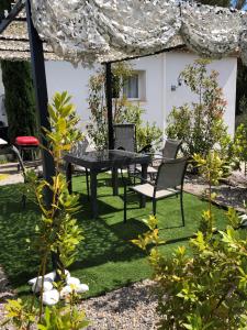 a patio with a table and chairs in a yard at Maxima Sunset in Sainte-Maxime