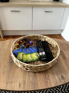 a basket filled with remote controls on a wooden floor at Les Suites Paloises - Appt. 4 : Le Parc Beaumont in Pau
