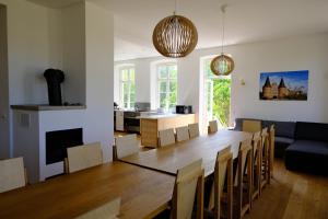 a dining room and living room with a table and chairs at Gutshaus FeWo Lübeck in Dassow