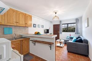 a kitchen and a living room with a couch at Punta del Sol Familiar in Tijarafe