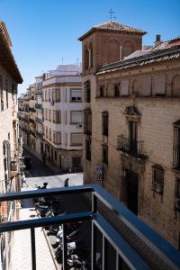a view of a city street from a balcony at VELALMA PISOS centro histórico in Jaén