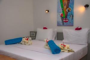 two stuffed cats are sitting on a bed at LITTLE POMPEJI Villa - Adults Only in Jambiani +31 photos