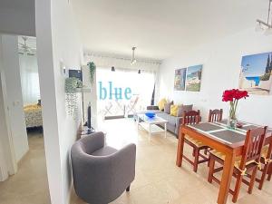 a living room and dining room with a table and chairs at El Salon, Nerja BLUEWATER VILLAS in Nerja