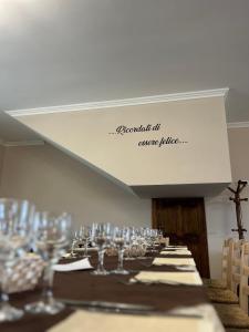 a long table with wine glasses on it at L’agrifoglio in Francavilla in Sinni
