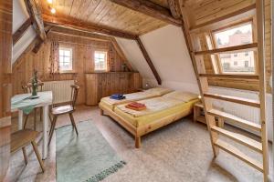 a bedroom with a bunk bed and a desk and a table at Ferienhaus "Zur Ottendorfer Hütte" in Ottendorf