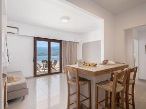 a kitchen and living room with a table and chairs at Porto Kaza in Sitia