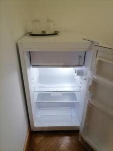 an empty refrigerator with its door open in a kitchen at Casa Bologna in Braşov