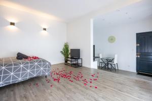 a room with red petals on the floor at Cosy Room Jacuzzi Romantique in Nantes