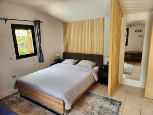 a bedroom with a large bed and a bathroom at Pension Lale in Peštani