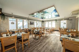 a restaurant with tables and chairs and a large window at Hotel Hanseport Hamburg in Hamburg